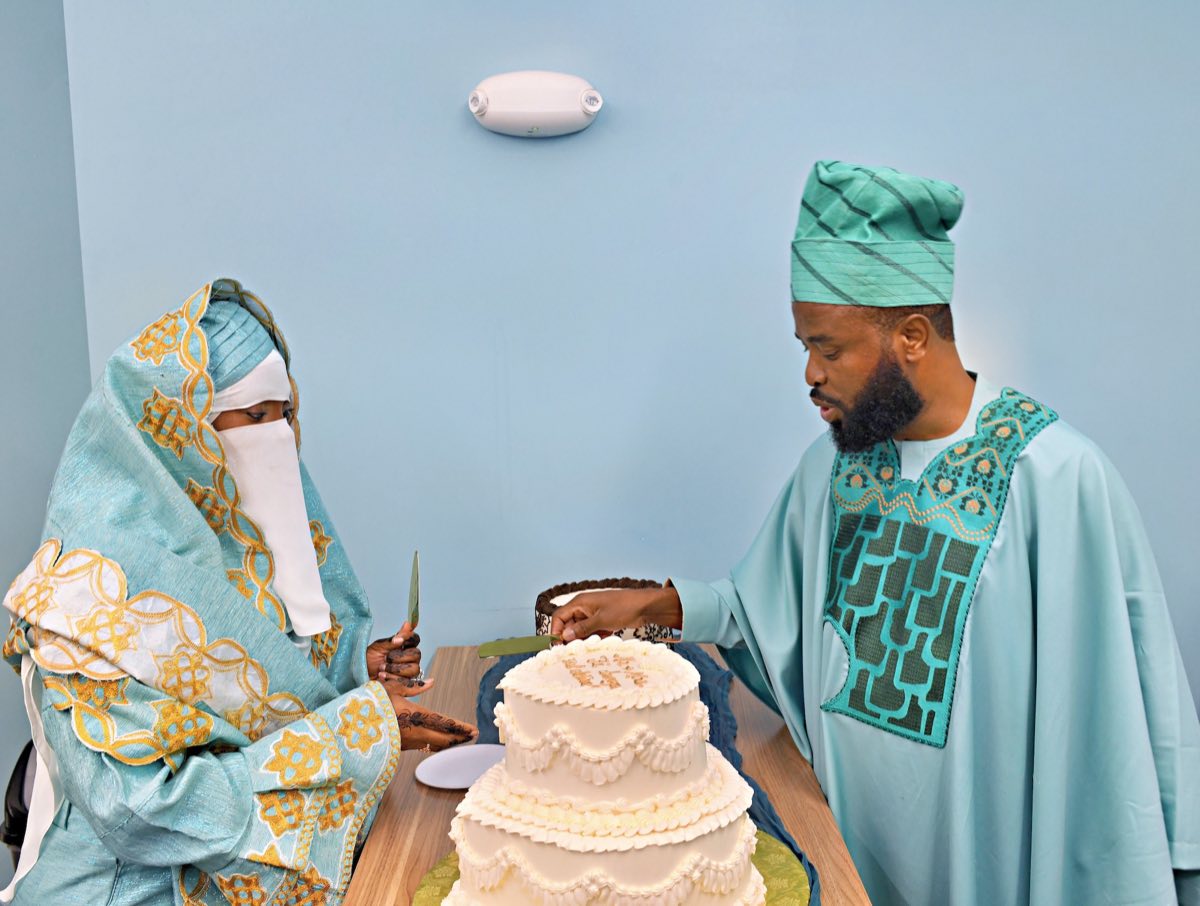 The couple cutting their wedding cake